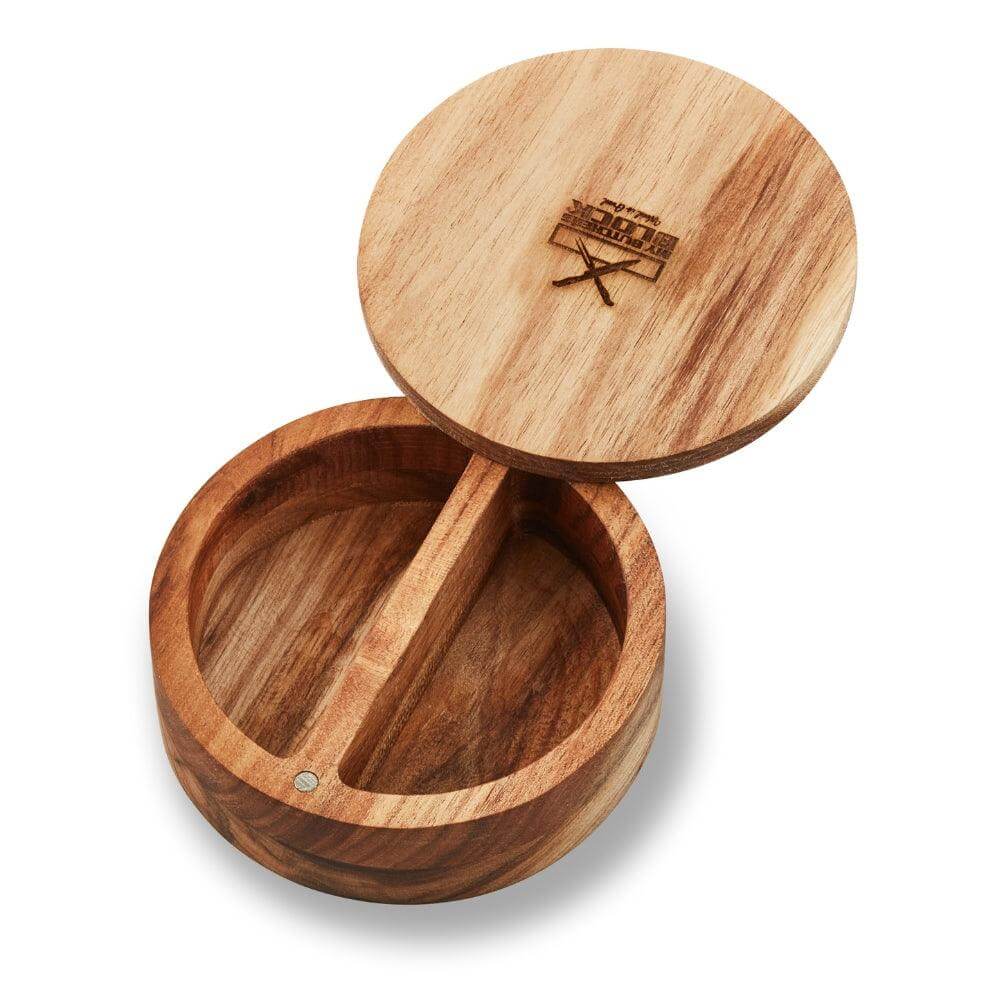 Natural wood salt and pepper holder with magnetic lid featuring two compartments for easy seasoning access.