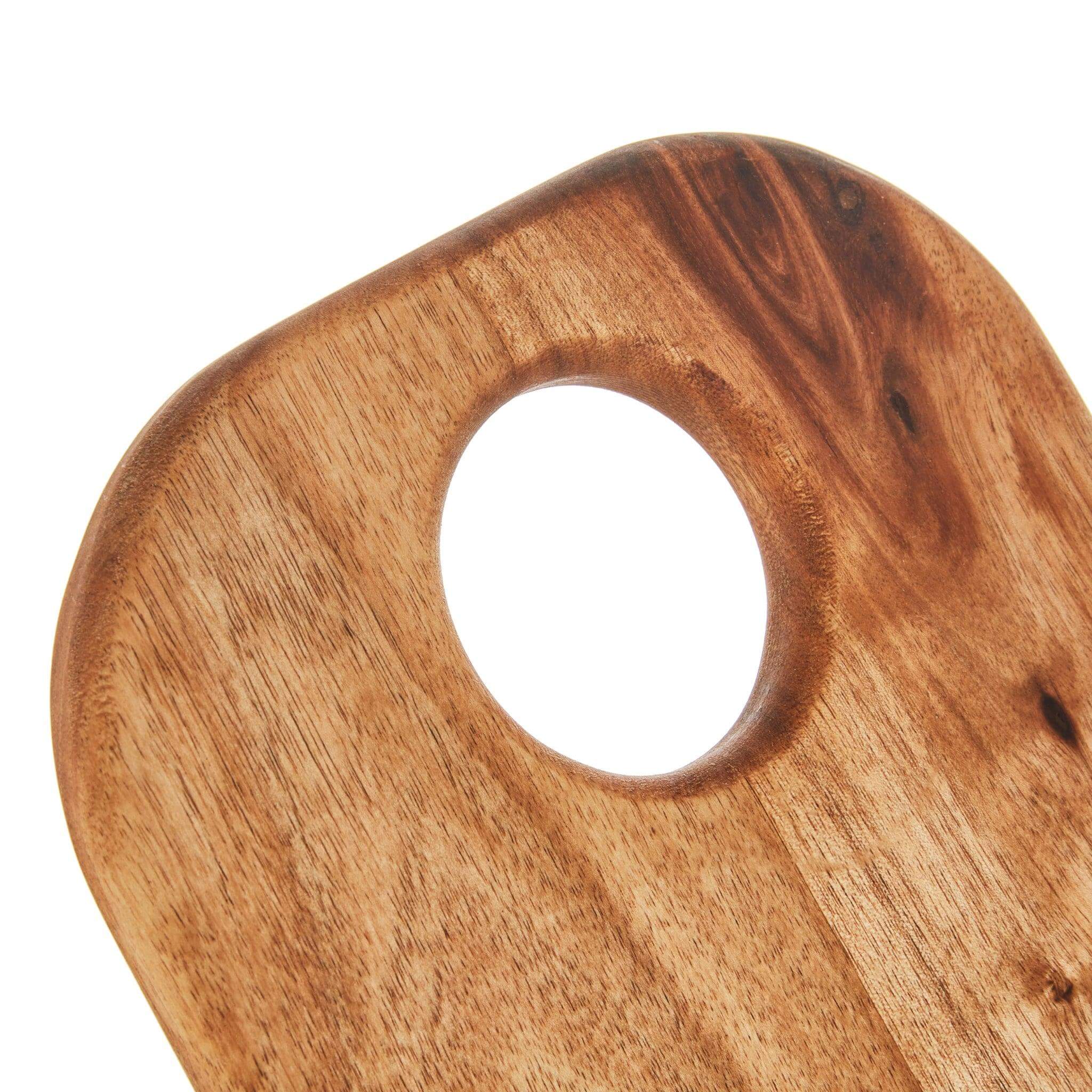 Close-up of a high-quality Acacia wood bread board with a round cutout for easy handling.