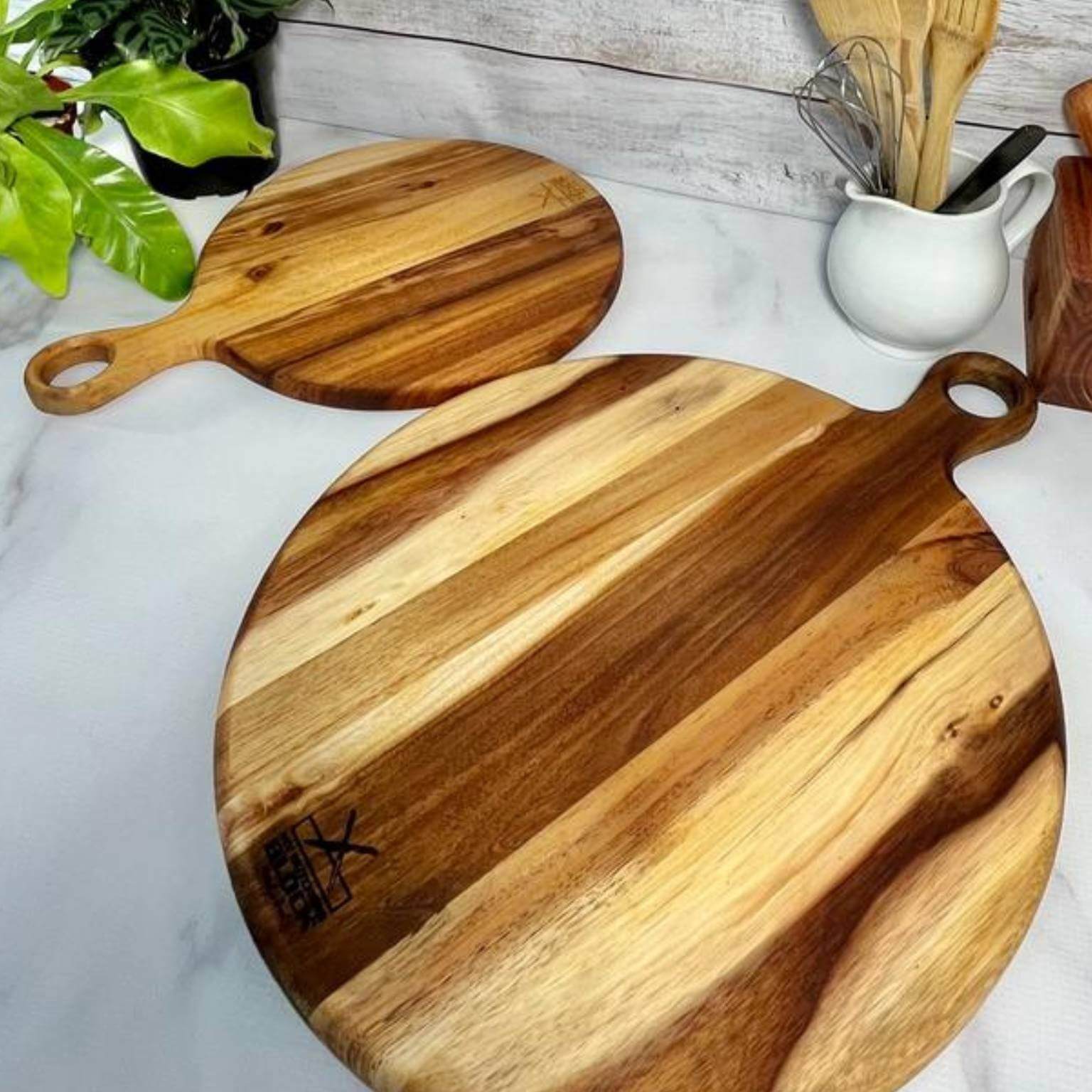 Round serving board medium in natural wood finish, perfect for slicing, chopping, and serving pizzas and charcuterie.
