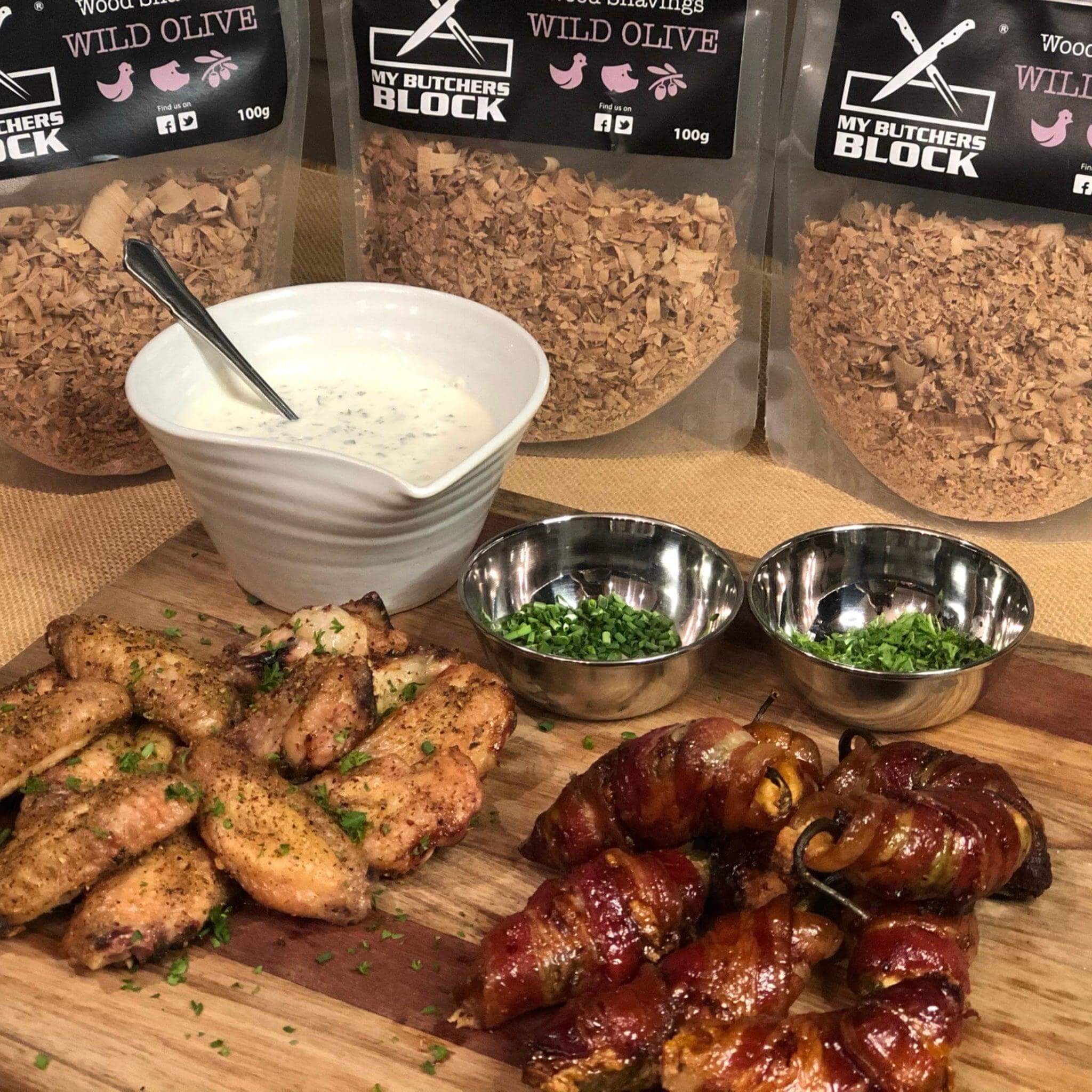Delicious smoked wings and gourmet dishes paired with wild olive smoking wood shavings and sauces.