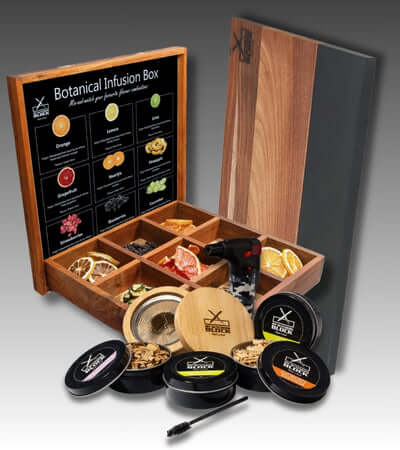 Botanical infusion box with assorted herbs, fruits, and a smoking tool for flavorful infusions.