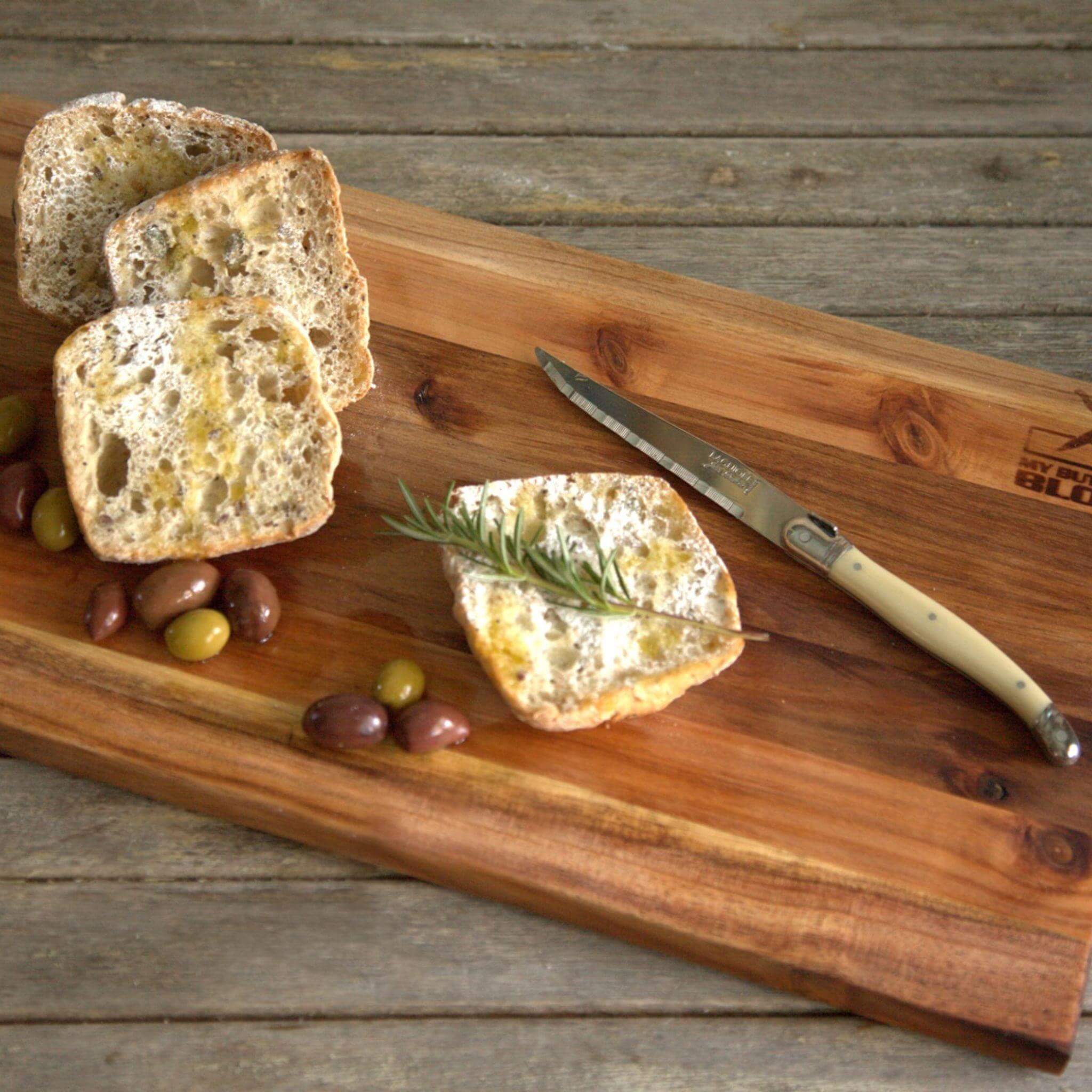 Basic Chopping Board - Small in use with bread and olives, styled on a rustic table.