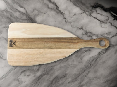 Wooden pizza peel with a smooth surface and handle, placed on a marble countertop.