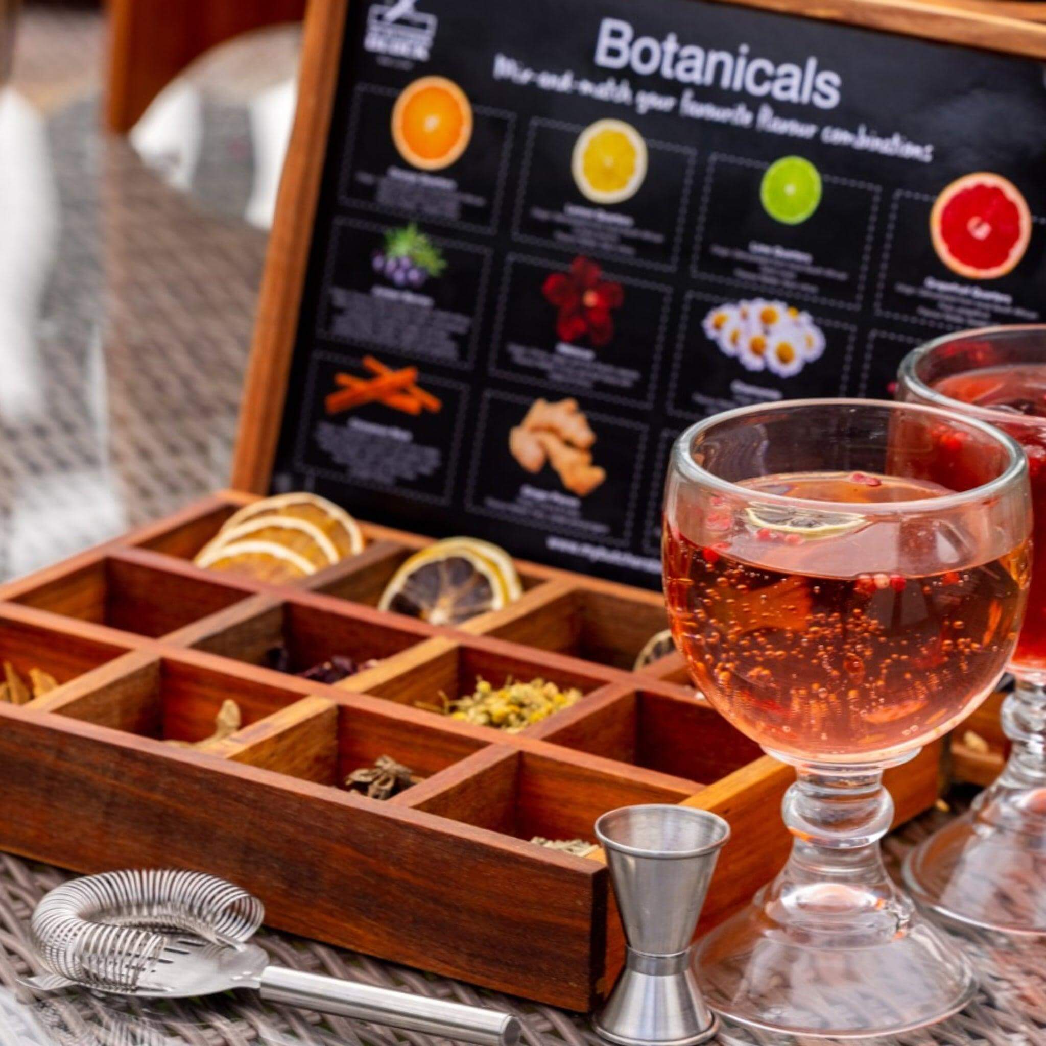 Botanical Infusion Box set up for a drink preparation scene, featuring a cocktail in a glass.