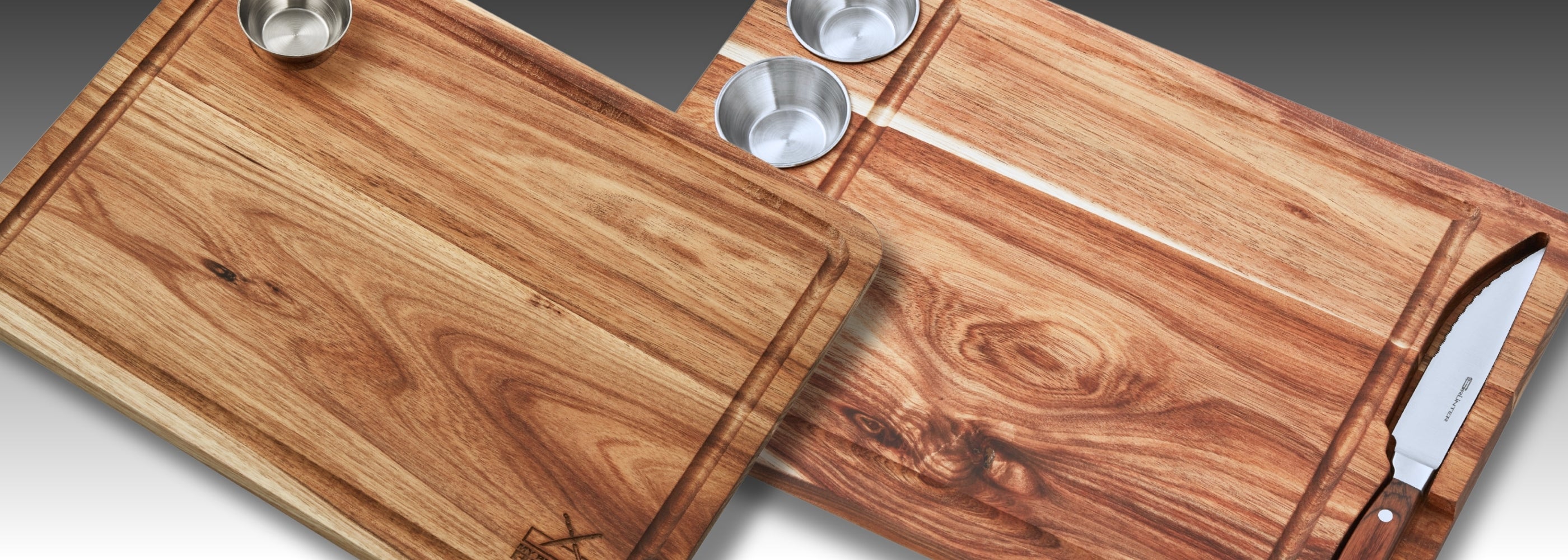 Two wooden cutting boards with metal cups and a knife, showcasing durable kitchen essentials.