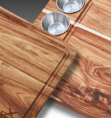 Two wooden cutting boards with metal cups and a knife, showcasing durable kitchen essentials.
