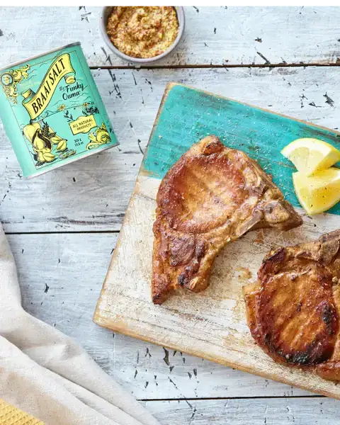 Grand Daddy Chopping Block + Funky Ouma Taste of Africa Gift Pack featuring grilled meat and braai salt on a wooden chopping board.