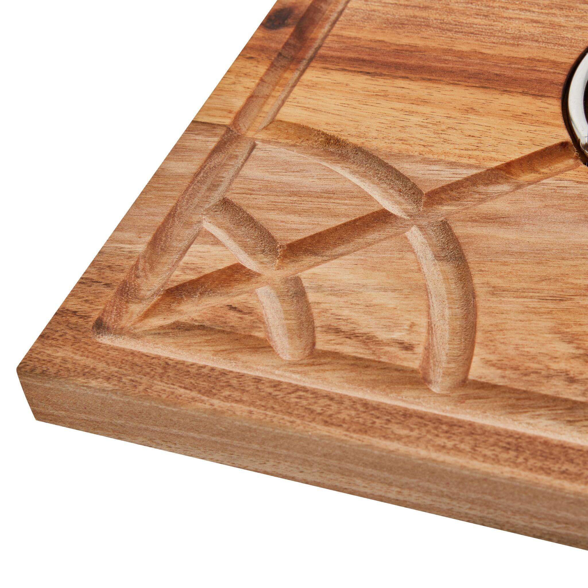 Detailed image of the carved design and logo on the corner of the Carving Board.