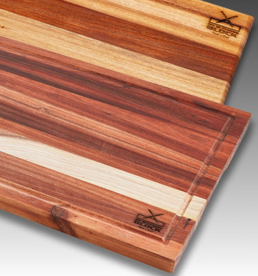 Wooden cutting boards featuring beautiful layered wood grain patterns and engraved logo.