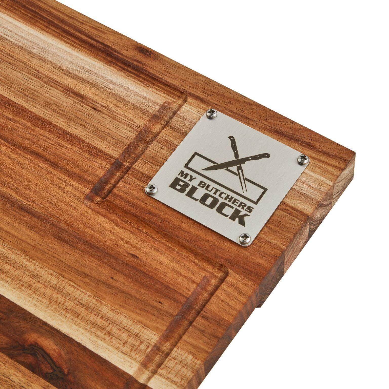 Handcrafted wooden butcher block with engraved metal plaque reading 'My Butchers Block'.