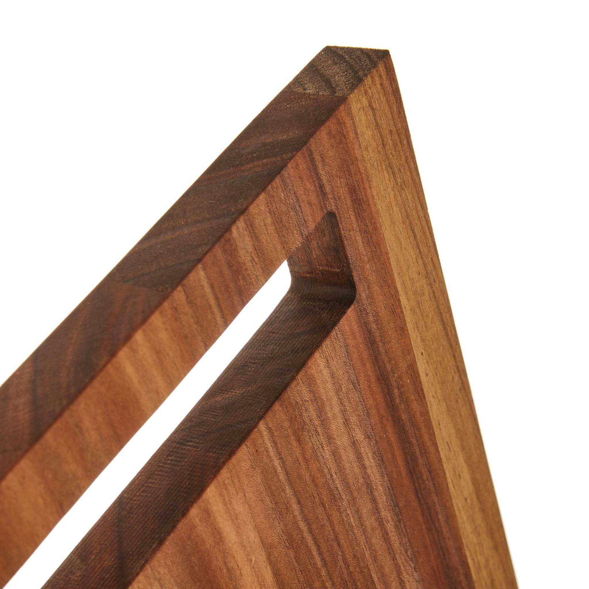 Close-up of the Handy Andy Board showcasing its sleek acacia wood design and unique angled edge.