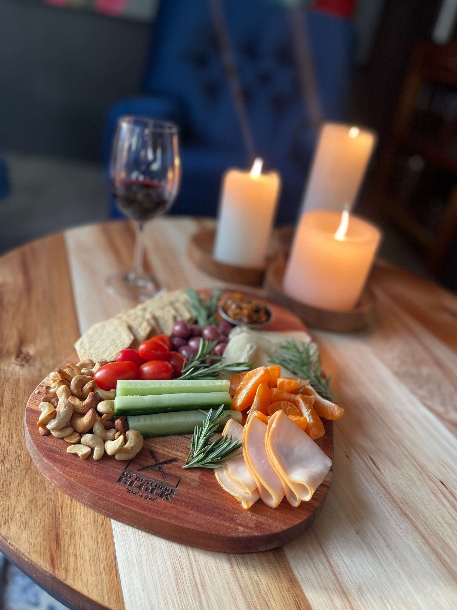 Elegant charcuterie spread on Small Paddle Board Old Design with wine and candles, perfect for hosting.