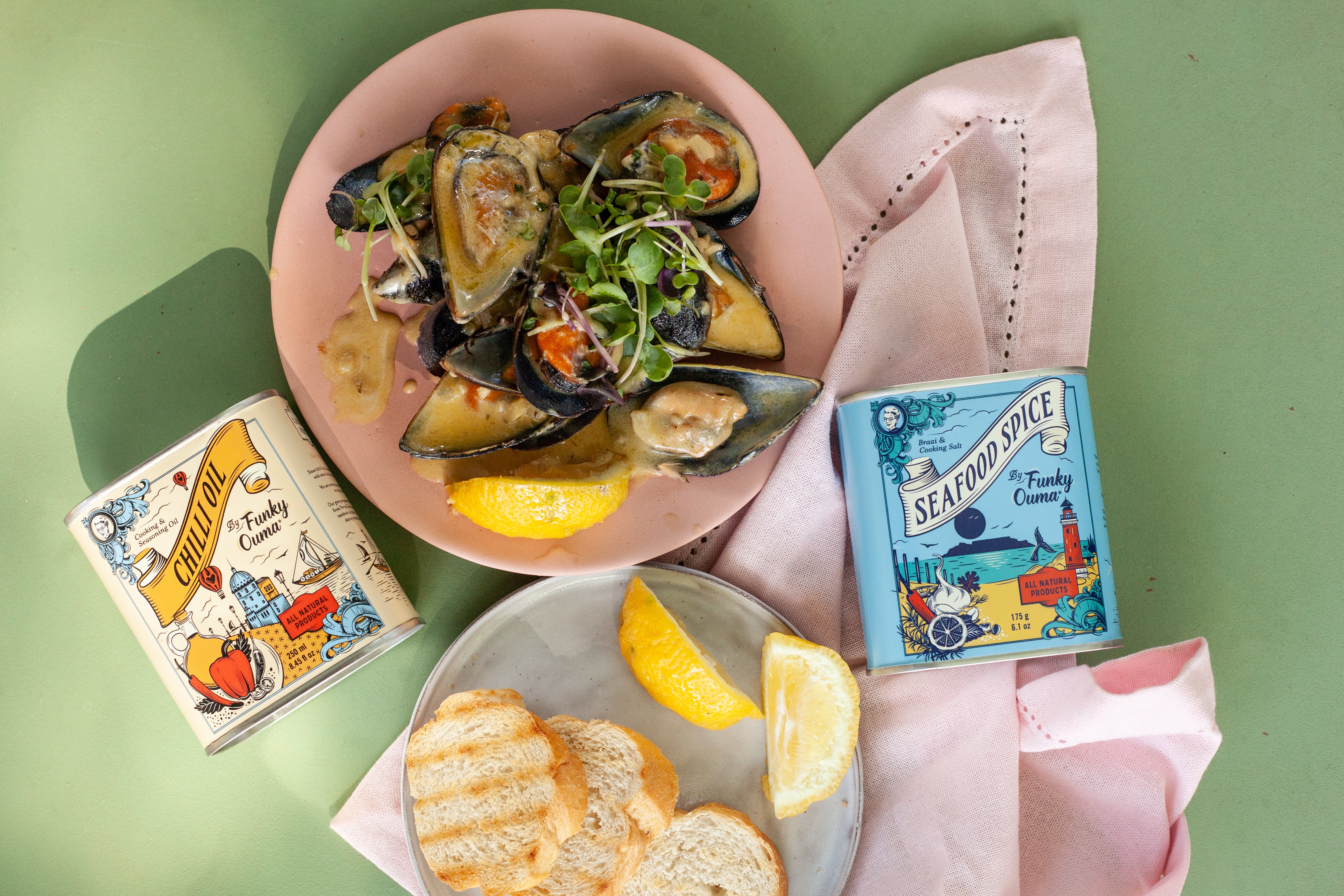 Delicious seafood dish with mussels, garlic butter, and spices, accompanied by lemon and bread.