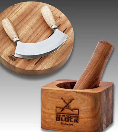 Rustic wooden butcher block with a curved knife and mortar, ideal for food preparation and cooking essentials.