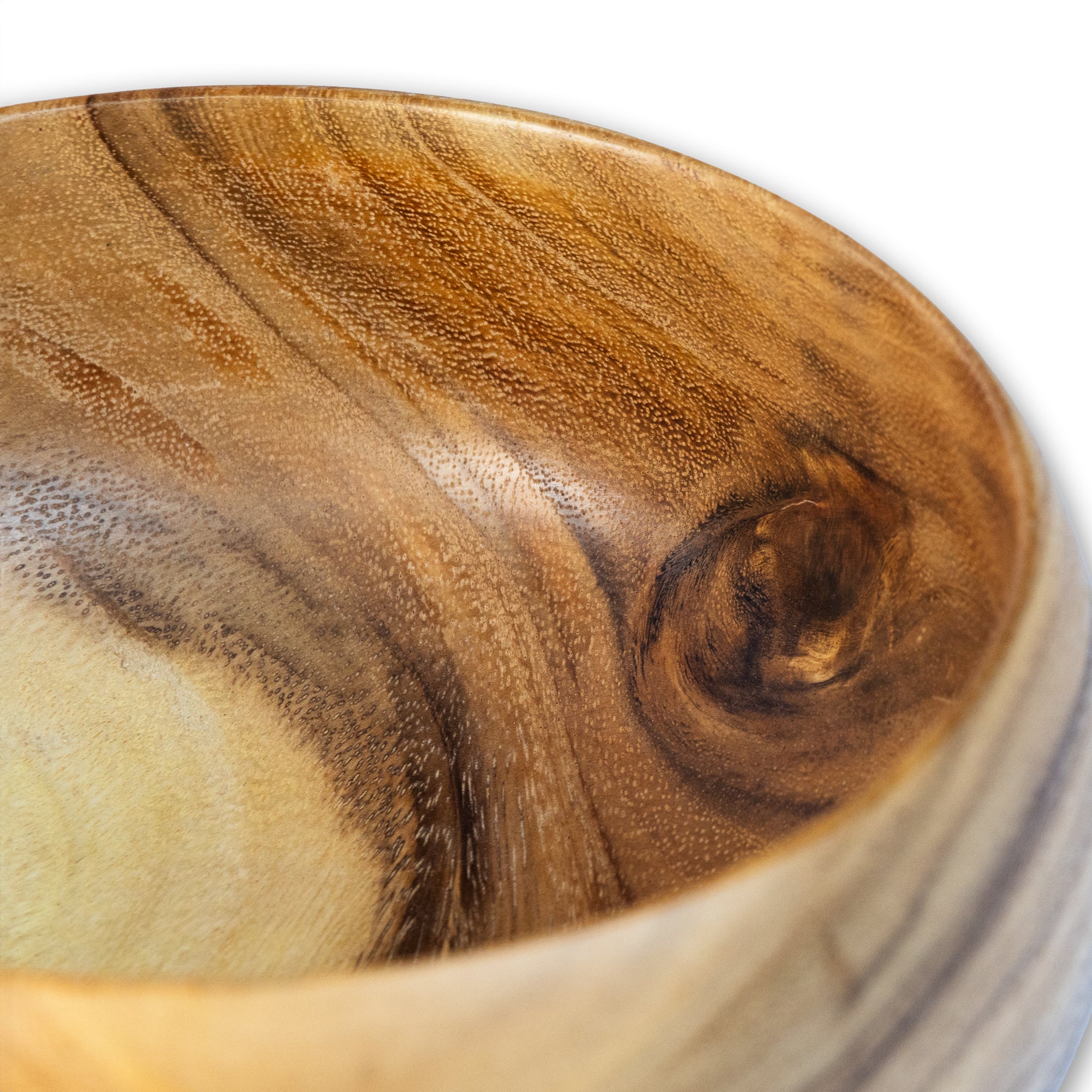 Close-up of a handcrafted round wooden bowl showcasing its unique grain and texture.