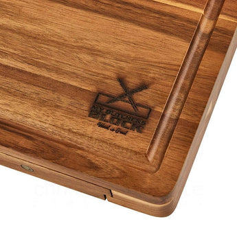 High-quality wooden chopping board featuring a carved logo and grooves for easy handling.