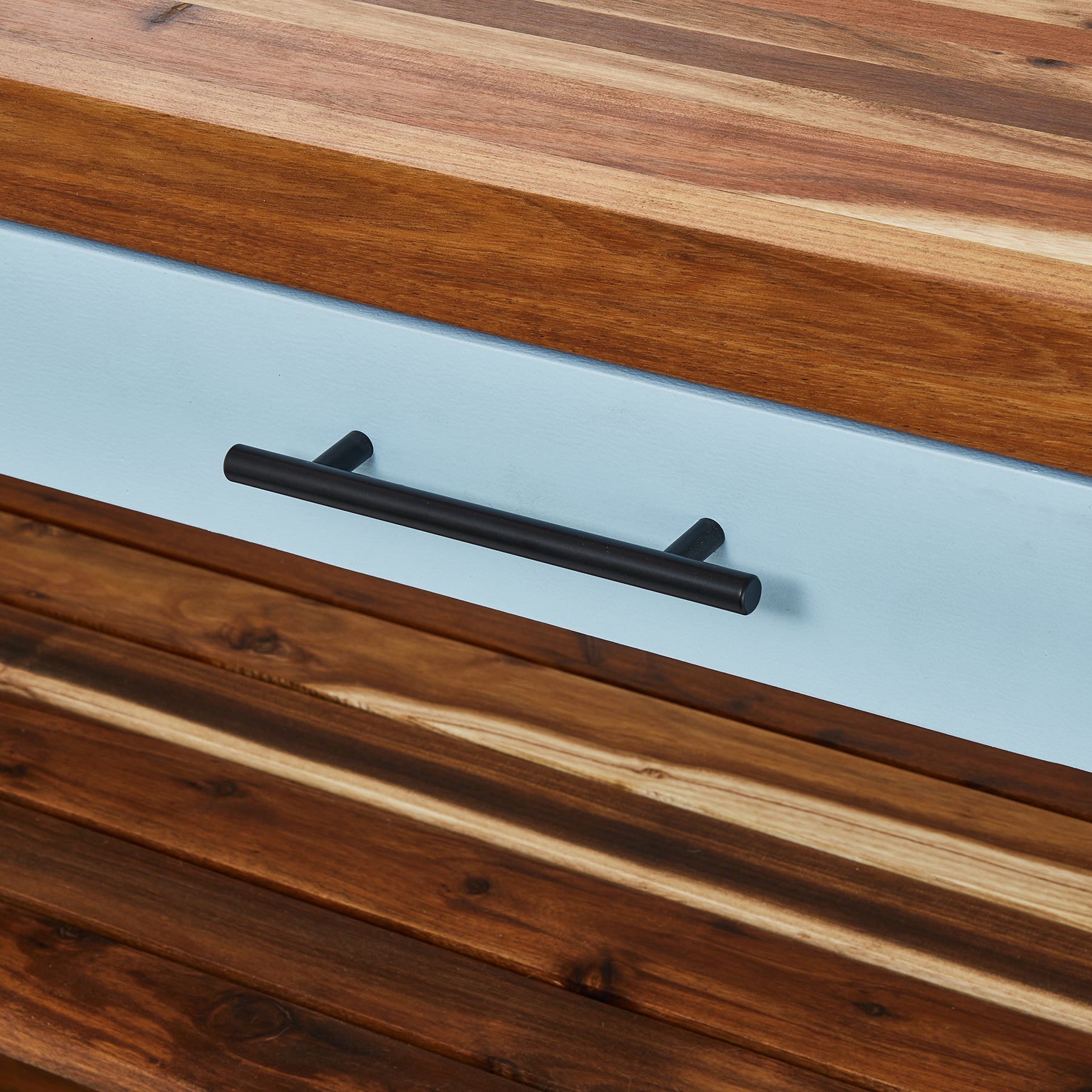 Close-up of the Butcher's Bench drawer handle showcasing durable wood and modern design.