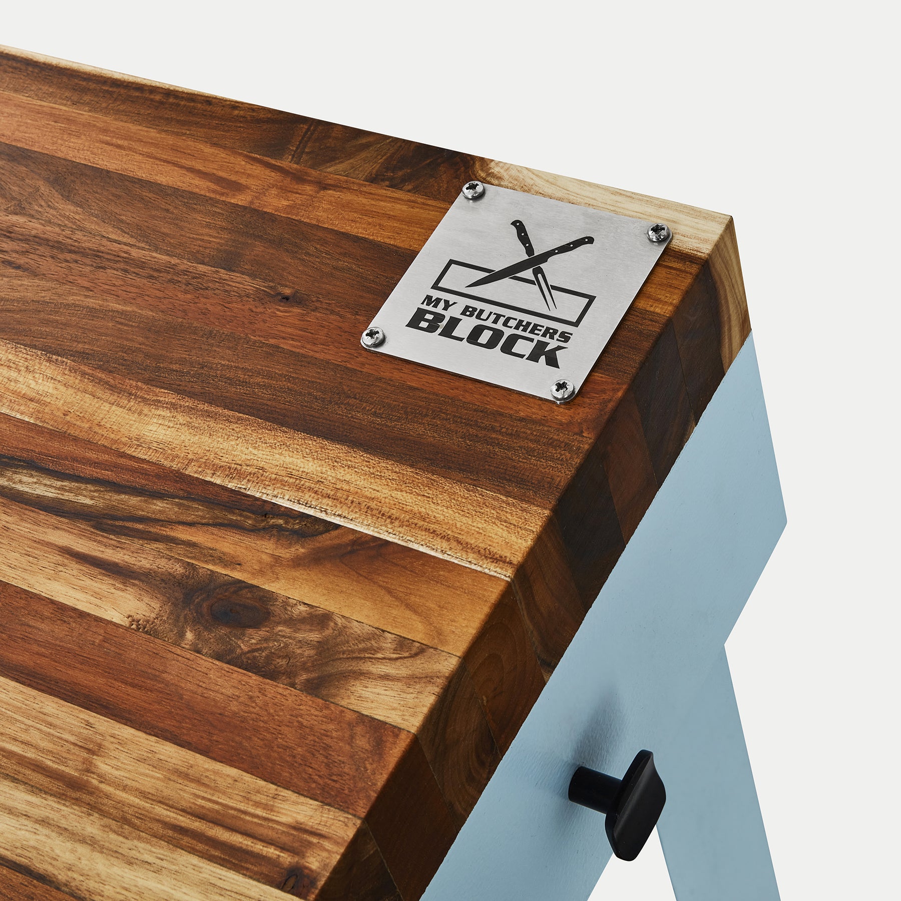 Close-up of a butcher's block showcasing the logo and wood grain detail, highlighting the craftsmanship and design.