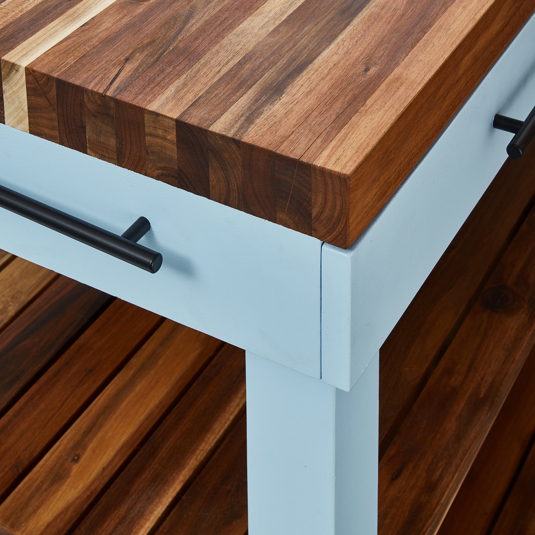Close-up of Butcher's Bench with solid wood top and steel frame, ideal for kitchen prep and braai setups.