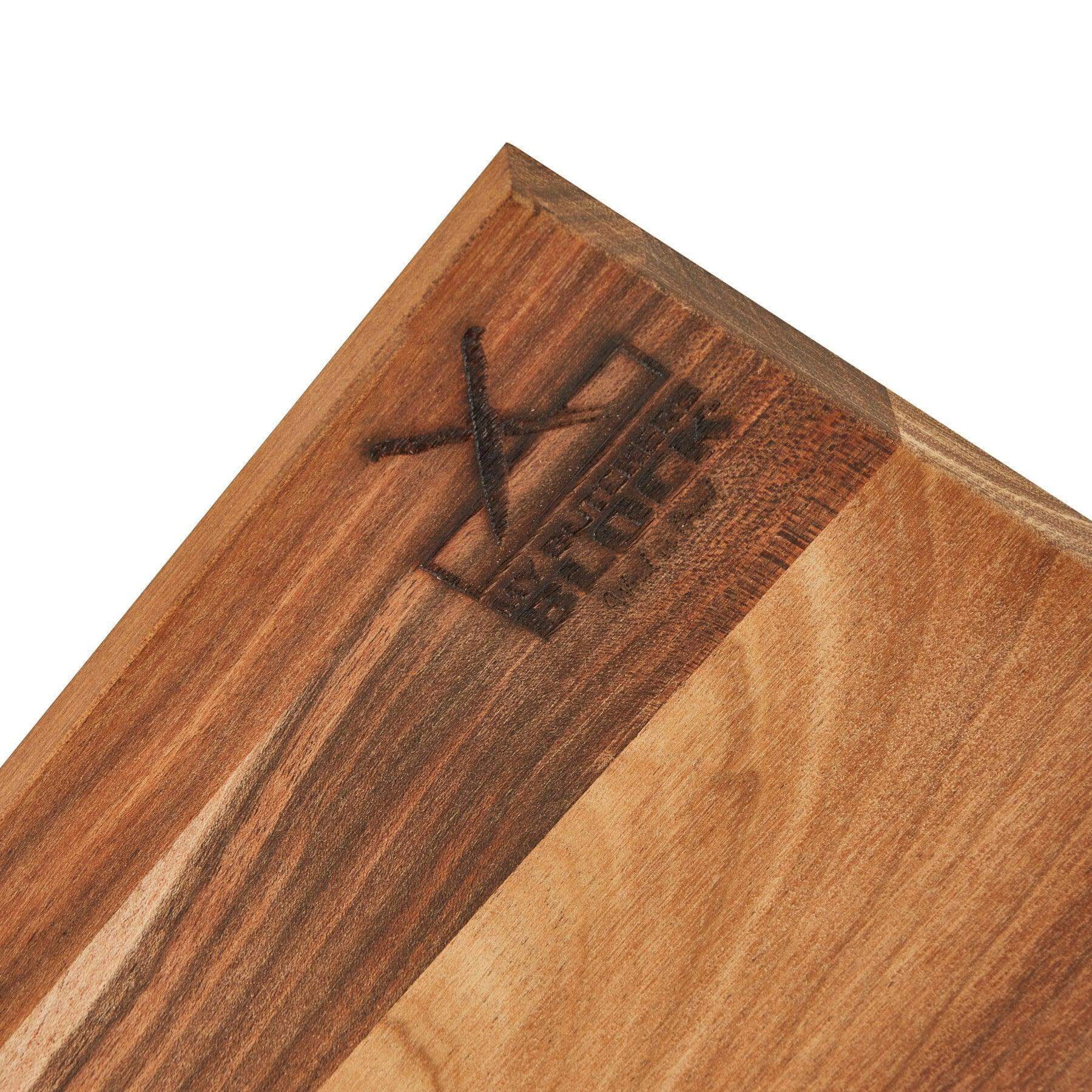 Close-up of the corner of a wooden Tasting and Pairing Board showcasing the engraved brand logo.