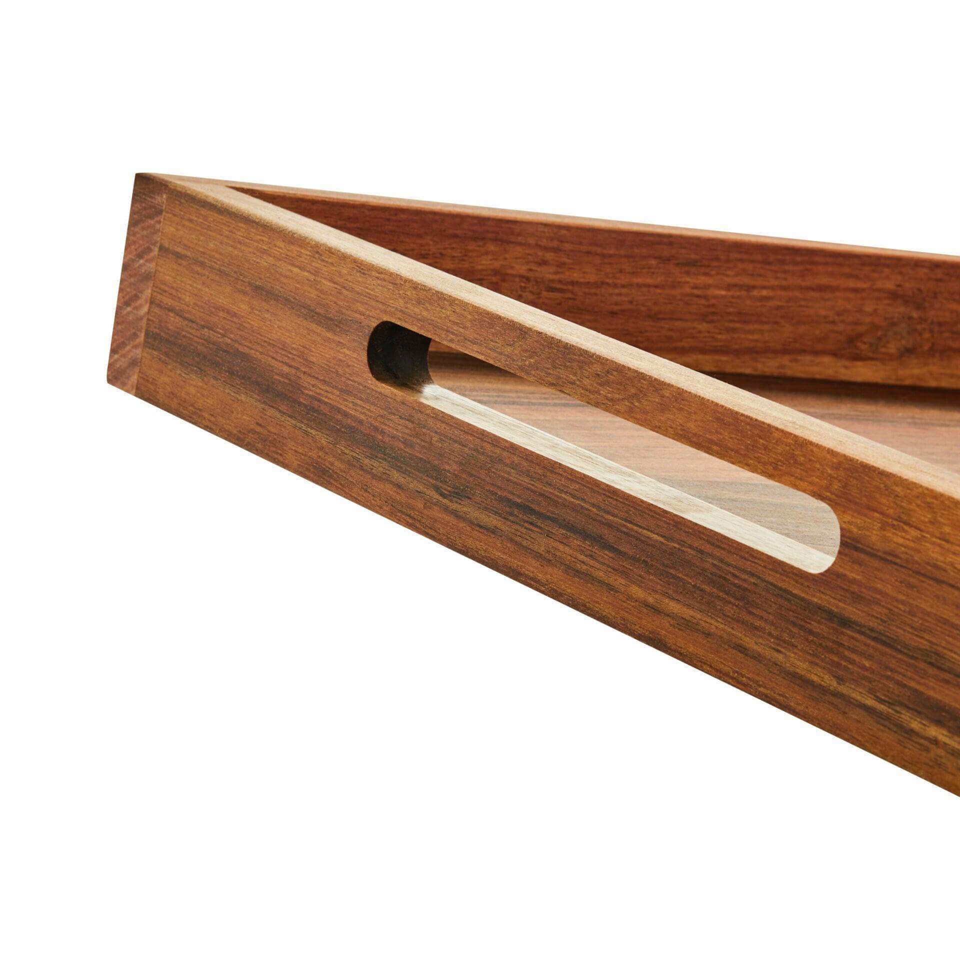 Close-up of a small acacia wood serving tray featuring a sleek design and handle cutout.