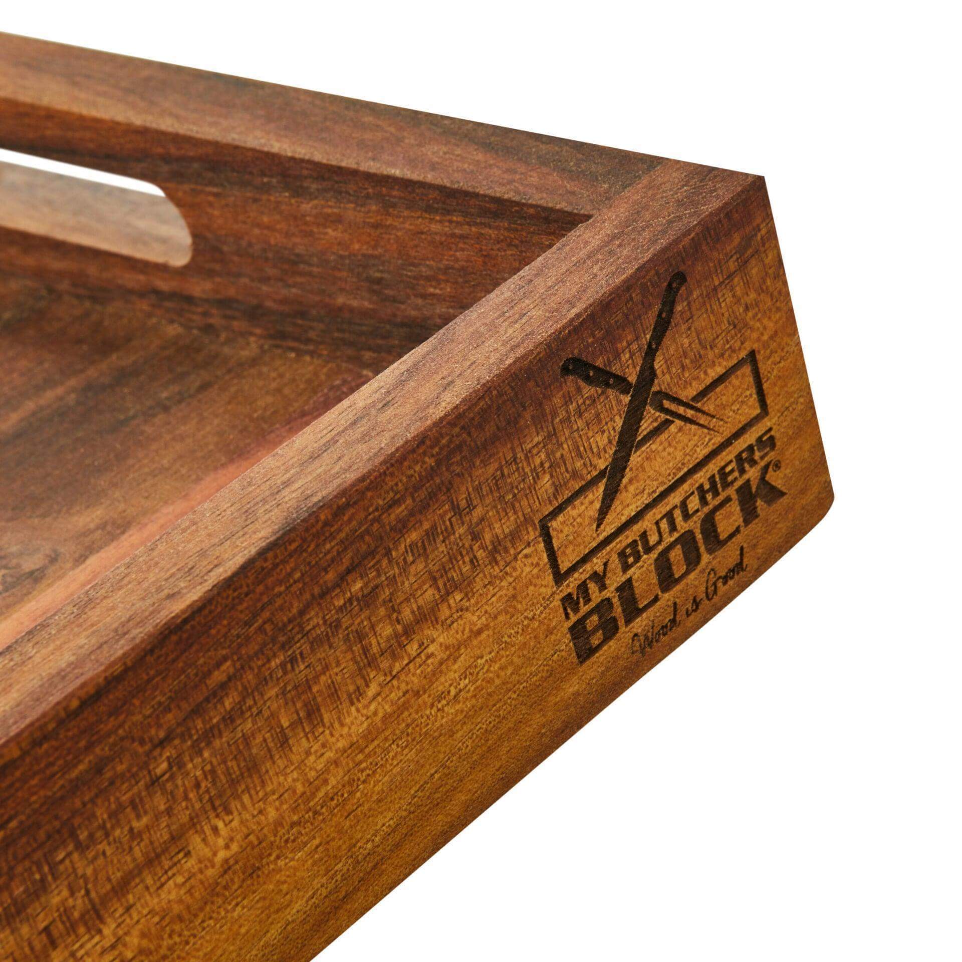 Close-up of a wooden serving tray with engraved logo, showcasing a rich Acacia wood finish.
