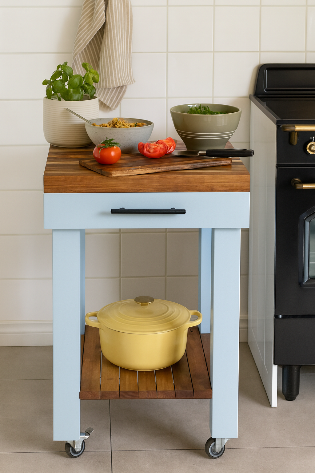 Stylish butcher's bench with solid wood top and blue finish, featuring fresh ingredients and a yellow pot underneath.