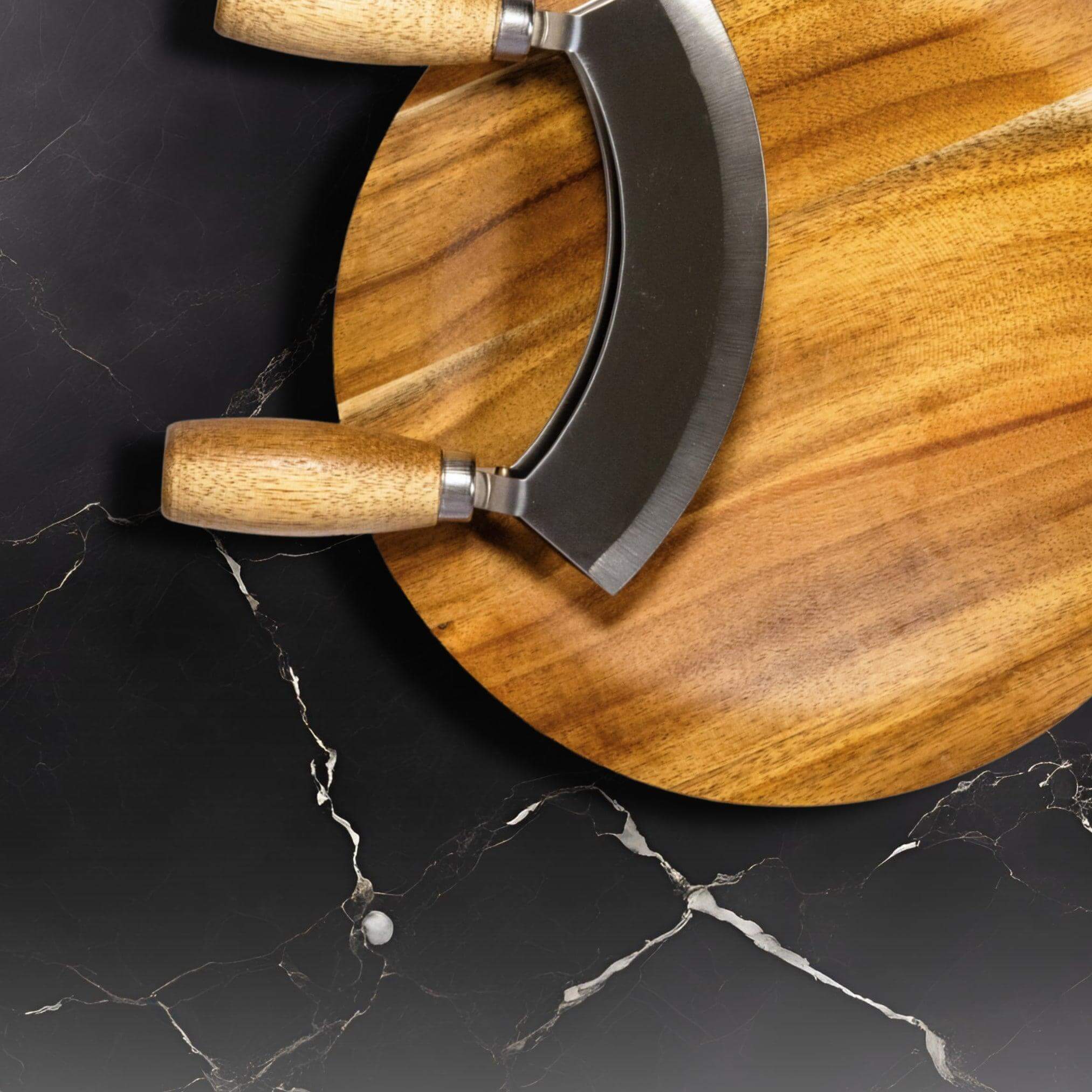 Close-up of a wooden Mezzaluna knife on a dark marble surface, showcasing its ergonomic design and craftsmanship.
