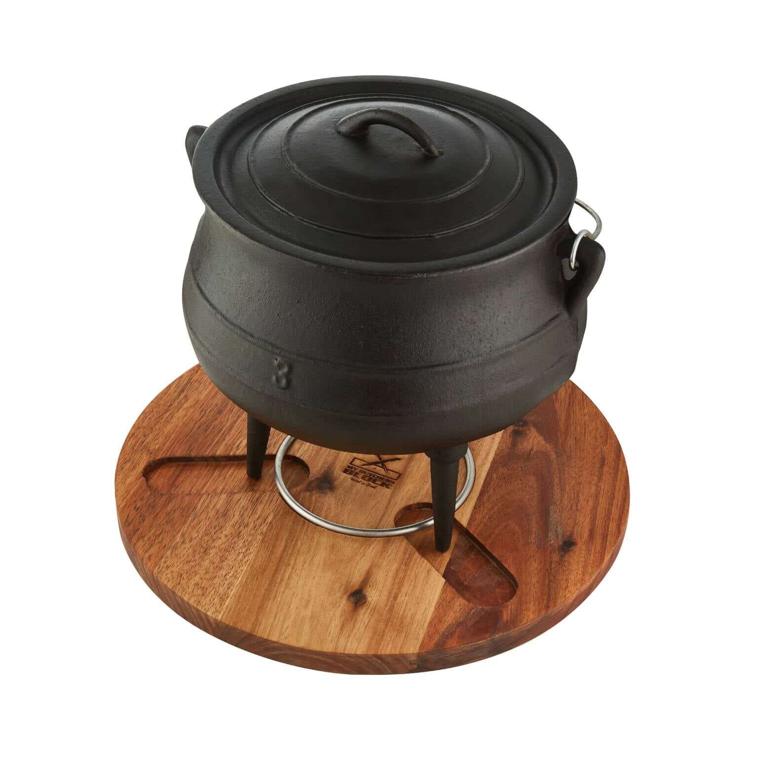 Potjie pot on a wooden chopping board stand, perfect for potjie lovers and cooking enthusiasts.