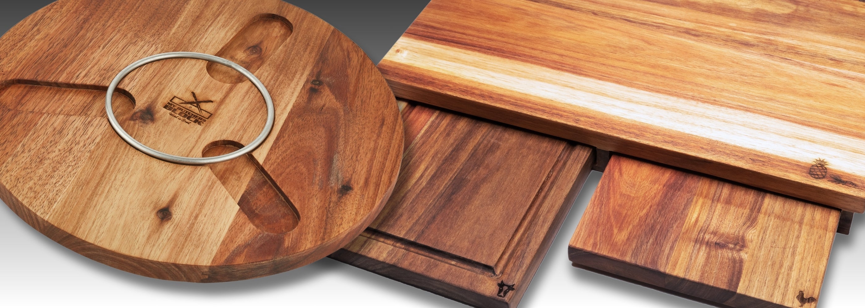 Elegant wooden serving boards and a circular platter, showcasing rich grain patterns and rustic charm.