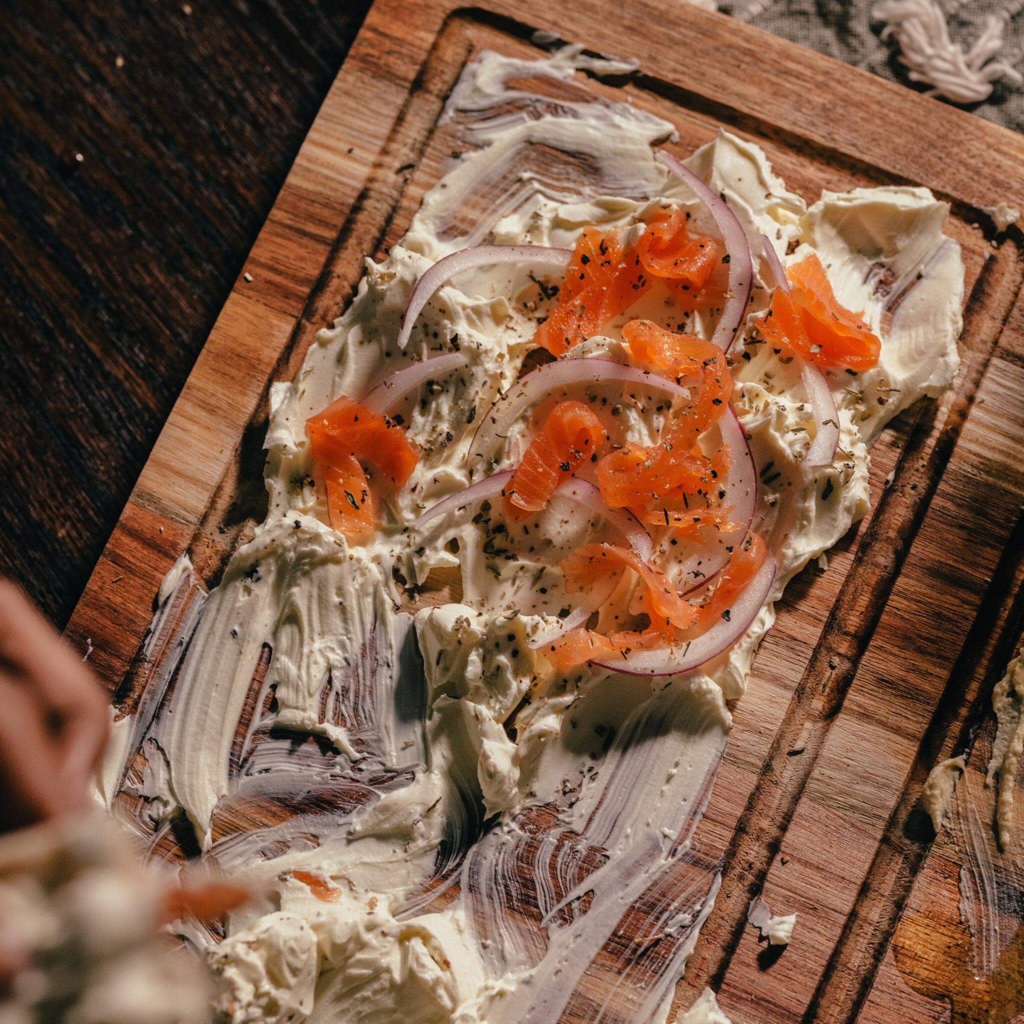 Plankie Braai Board Small featuring cream cheese, salmon, and onions for serving aesthetics.