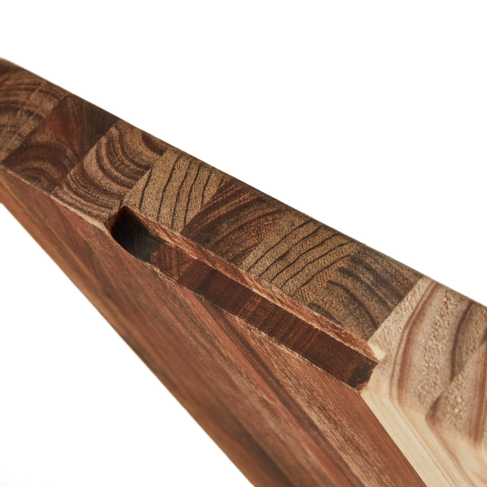 Close-up of the Braai and Slice Master Block, showcasing its durable wood texture and unique carving features.