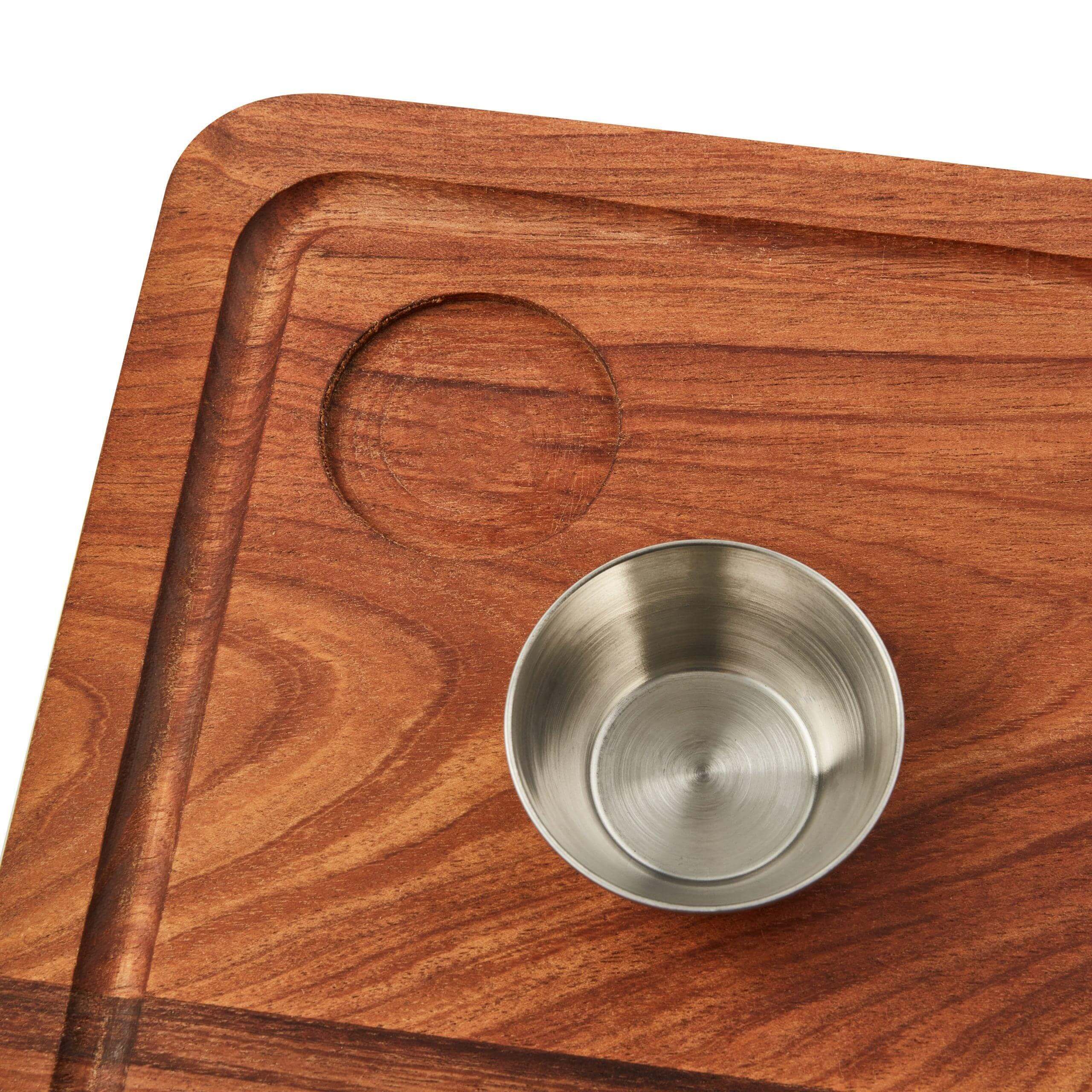 Acacia wood steak board with juice groove and stainless steel sauce bowl design.