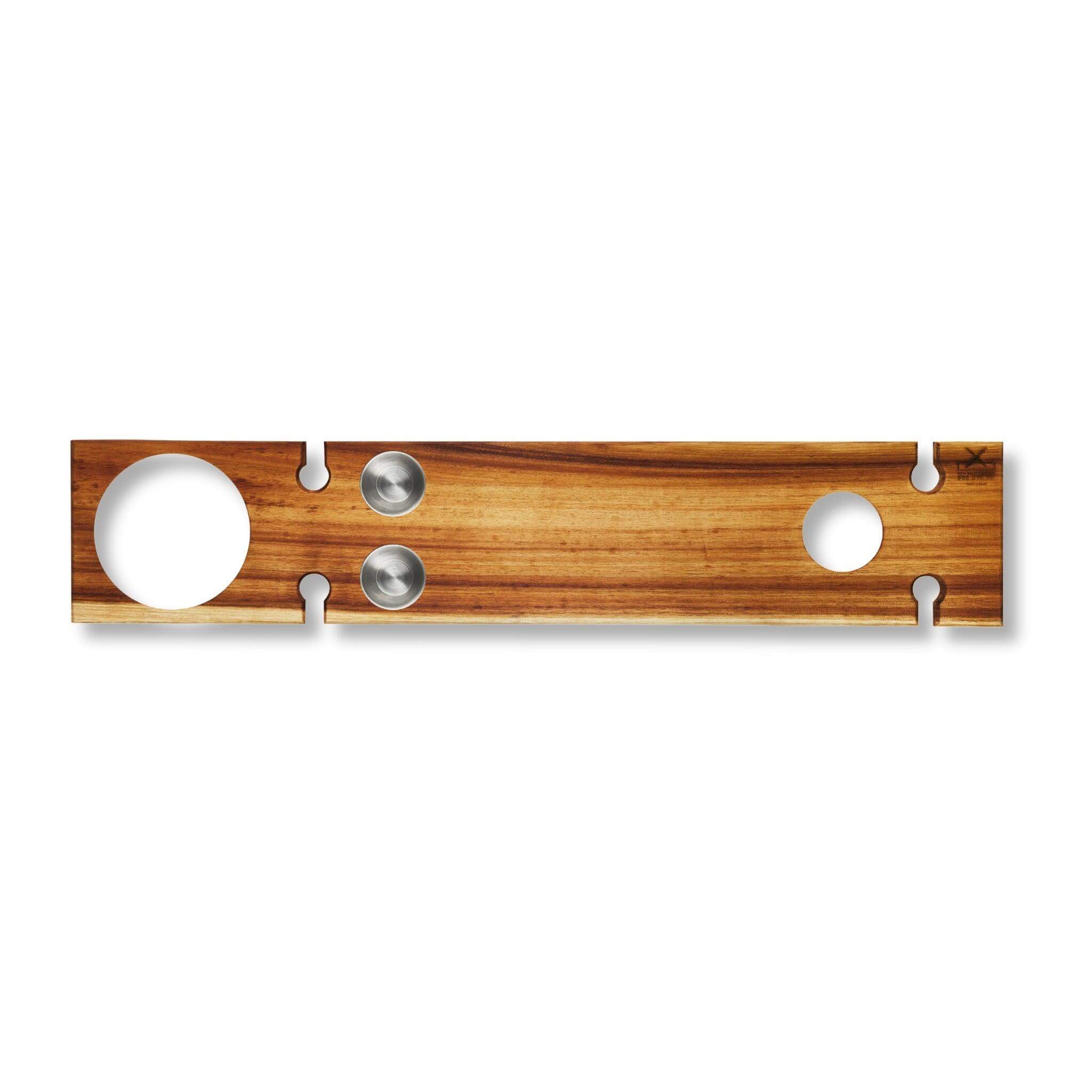 Wooden serving board with two holes for bowls, ideal for stylish grazing at outdoor picnics.
