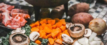 A pot with vegetables and meat prepared for a traditional South African winter meal, showcasing hearty ingredients.