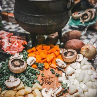 A pot with vegetables and meat prepared for a traditional South African winter meal, showcasing hearty ingredients.