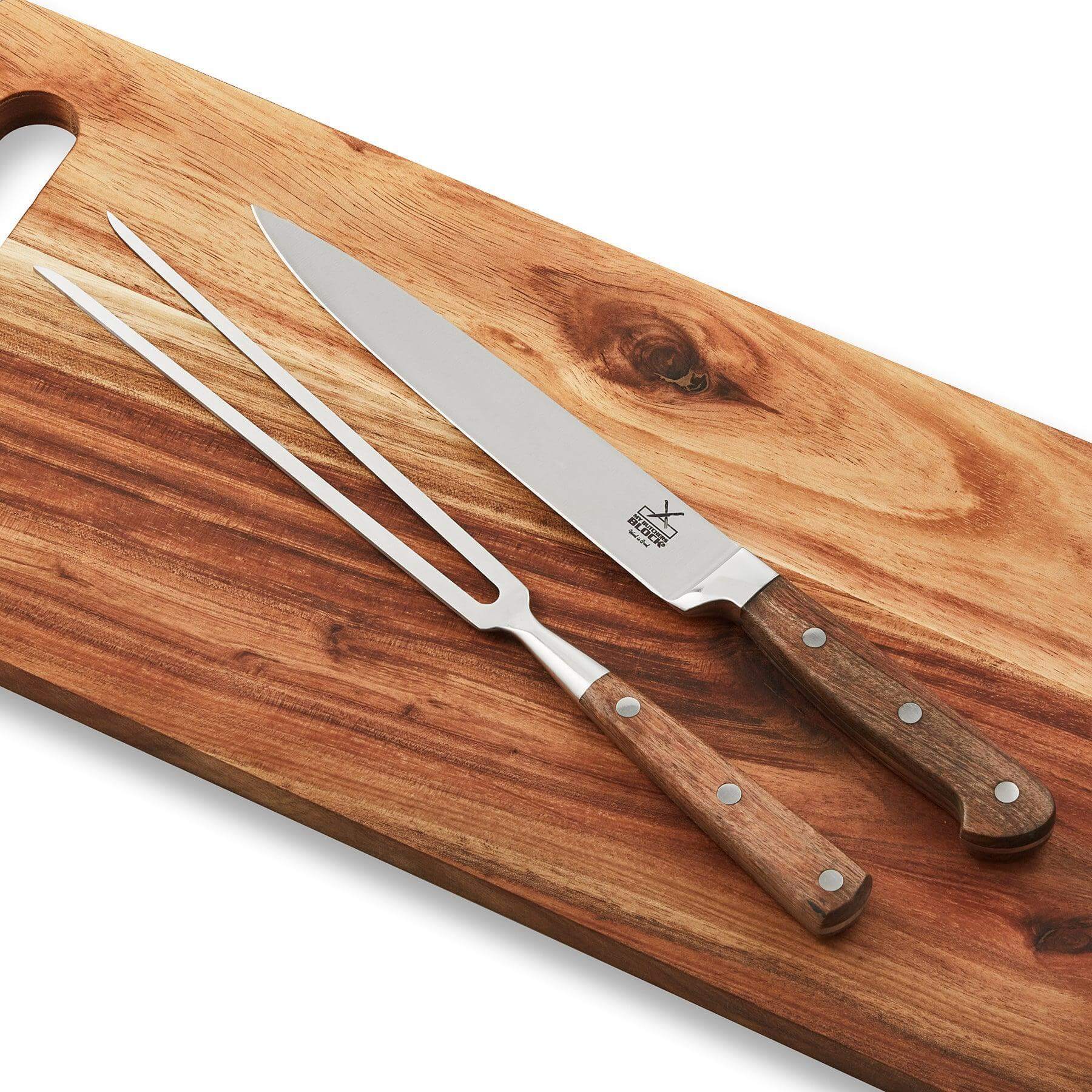 Premium carving knife set featuring stainless steel knife and fork on a wooden cutting board.