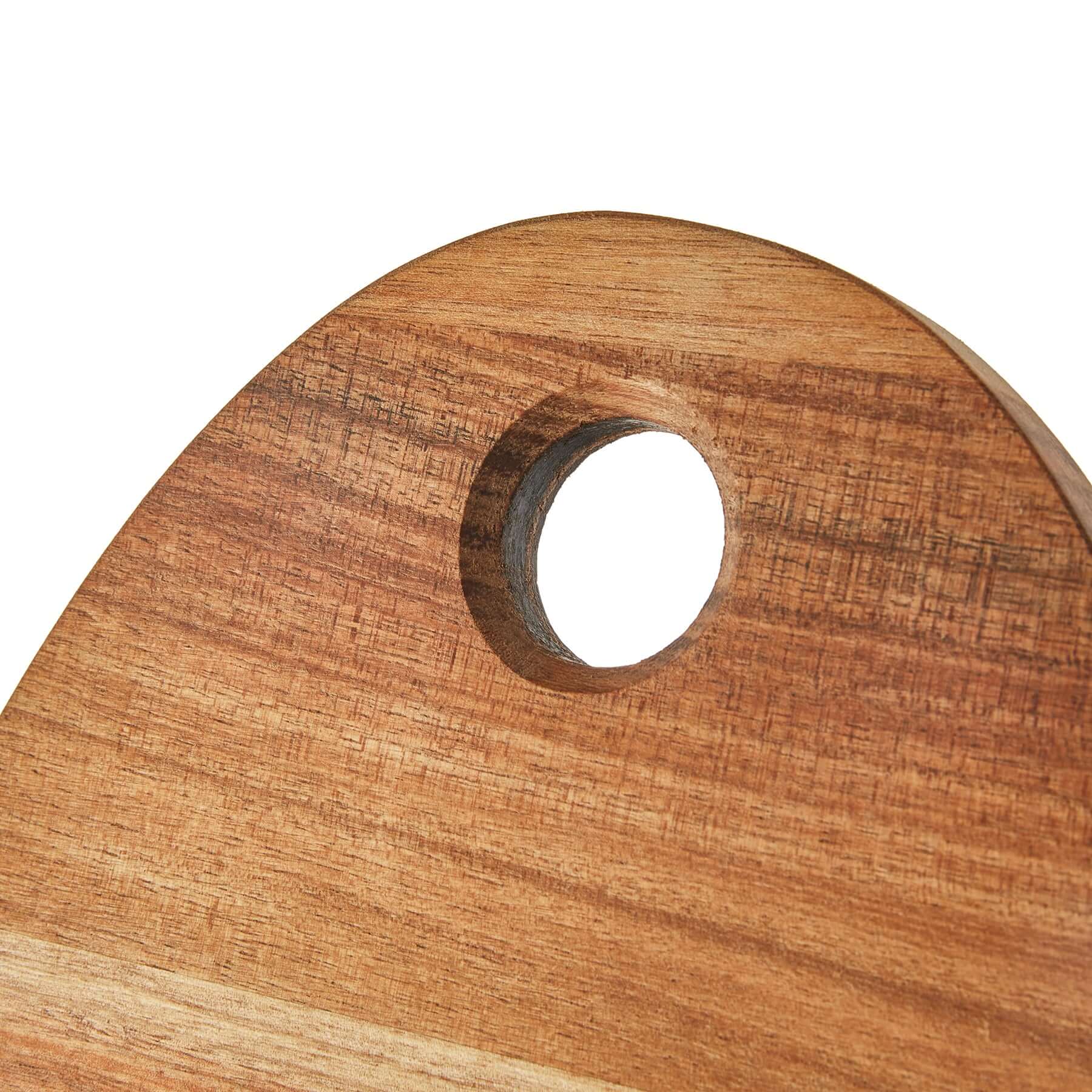 Close-up of paddle board small old design, showcasing its wooden texture and rounded edge with a hanging hole.