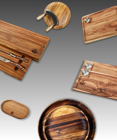 Collection of premium wooden kitchen accessories including cutting boards and bowls.