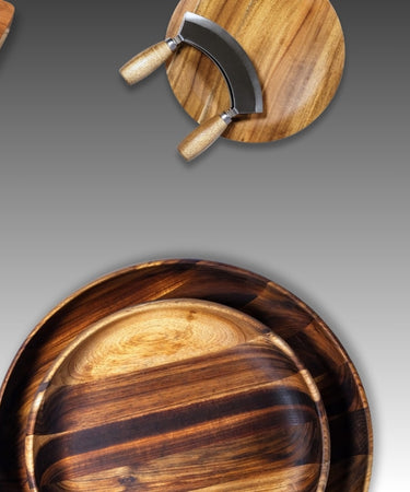 Collection of elegant wooden kitchen accessories including cutting boards and knife set on a gradient background.
