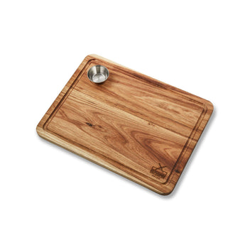 Large wooden steak board with built-in bowl, ideal for serving and entertaining with South African flavors.