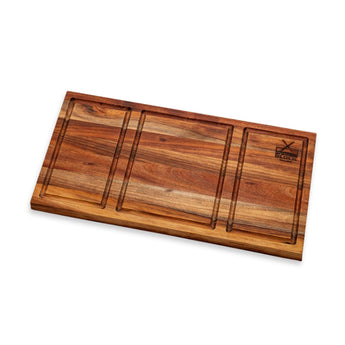 Shisanyama Plankie Braai Board Small with three sections and juice grooves on a wooden surface.